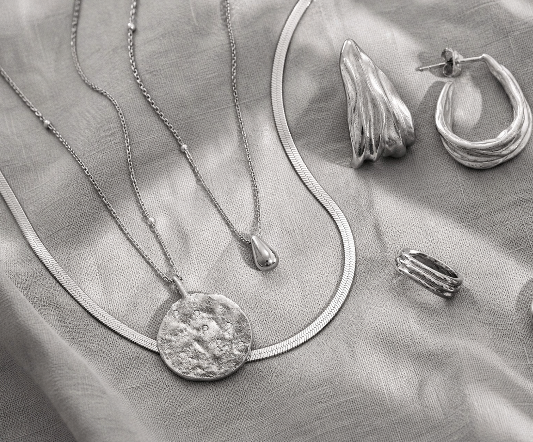 Curated jewellery collection arranged in monochrome editorial styling.