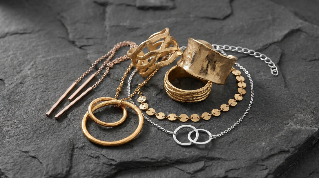 Layered sculptural jewellery styled in monochrome editorial photography.