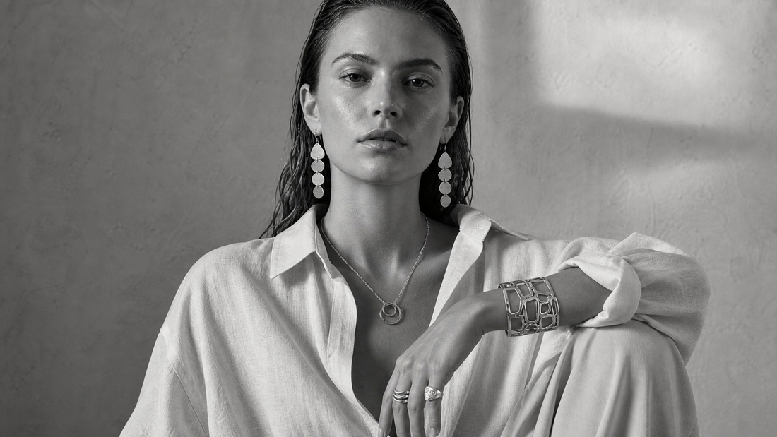 Woman wearing layered Silver jewellery with linen and relaxed tailoring in monochrome styling.