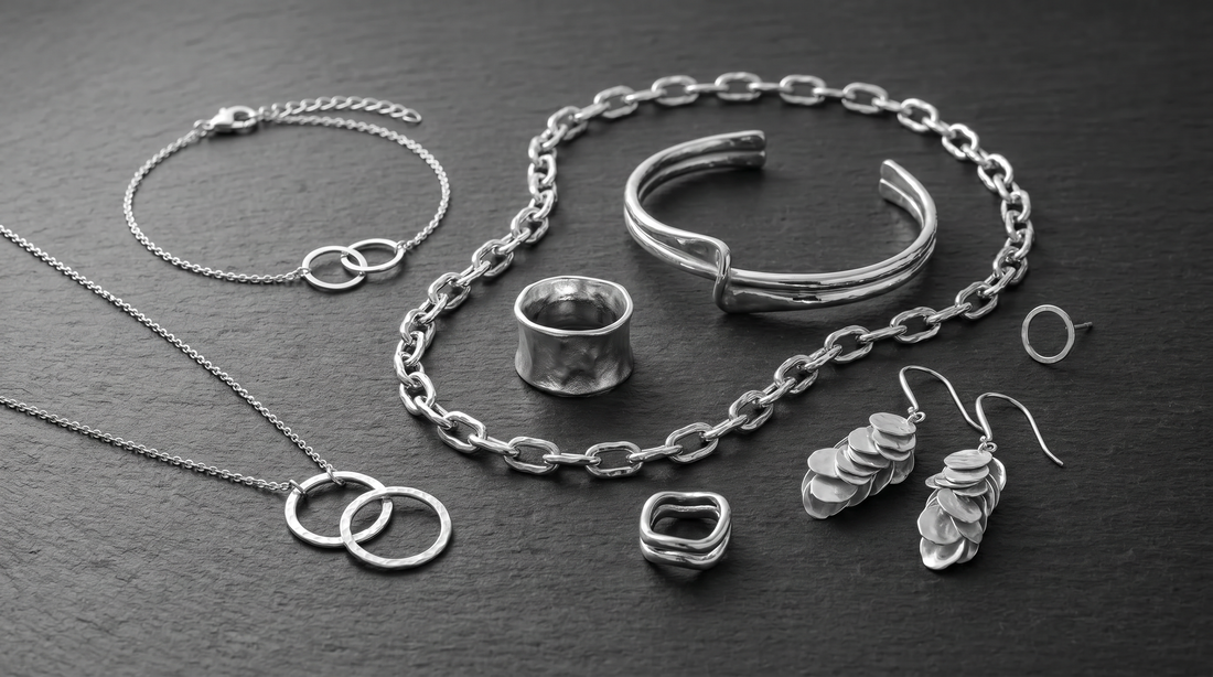 Minimal jewellery styled in black and white editorial photography.