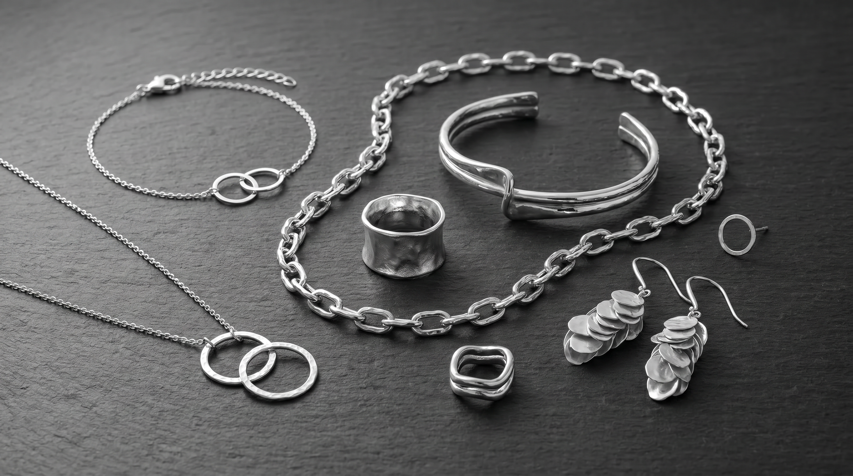 Minimal jewellery styled in black and white editorial photography.