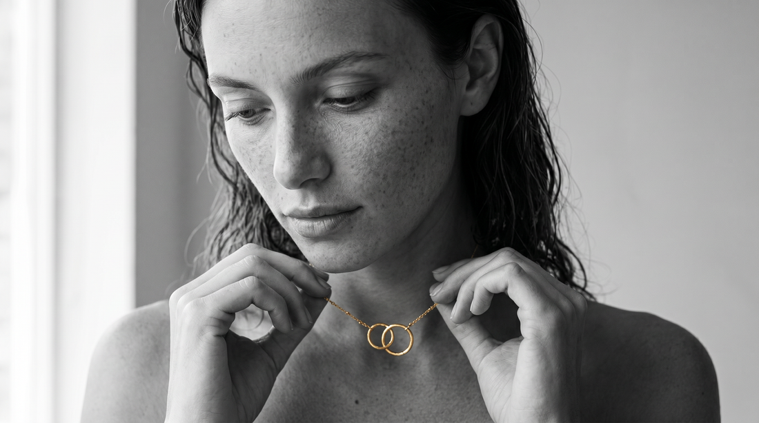 Woman wearing a meaningful everyday necklace in black and white editorial photography.