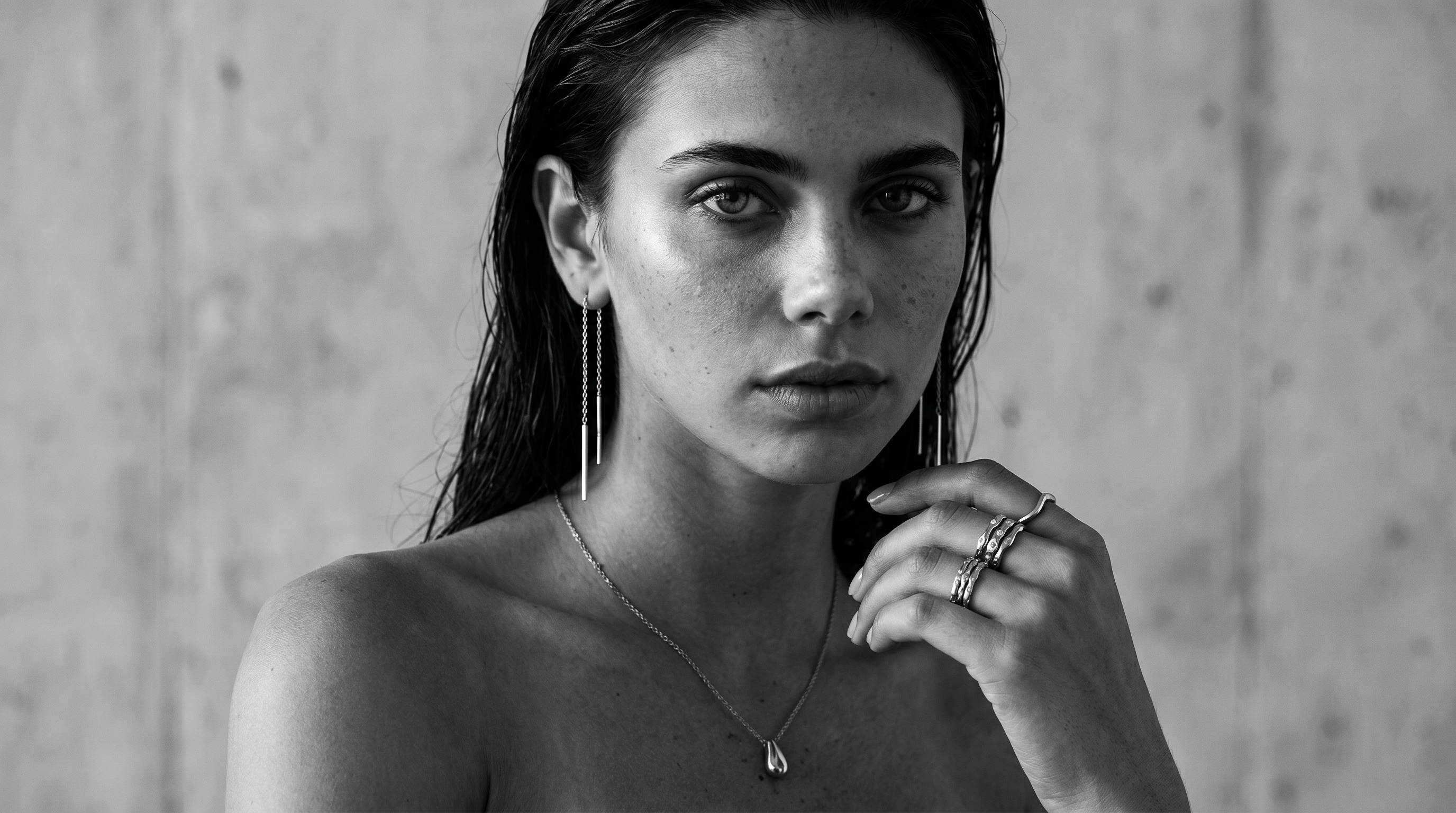 Woman wearing sculptural jewellery in black and white styling.