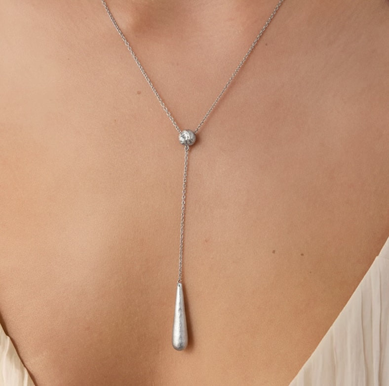 Sculptured Silver lariat necklace Australia. Teardrop pendant on a person's neck