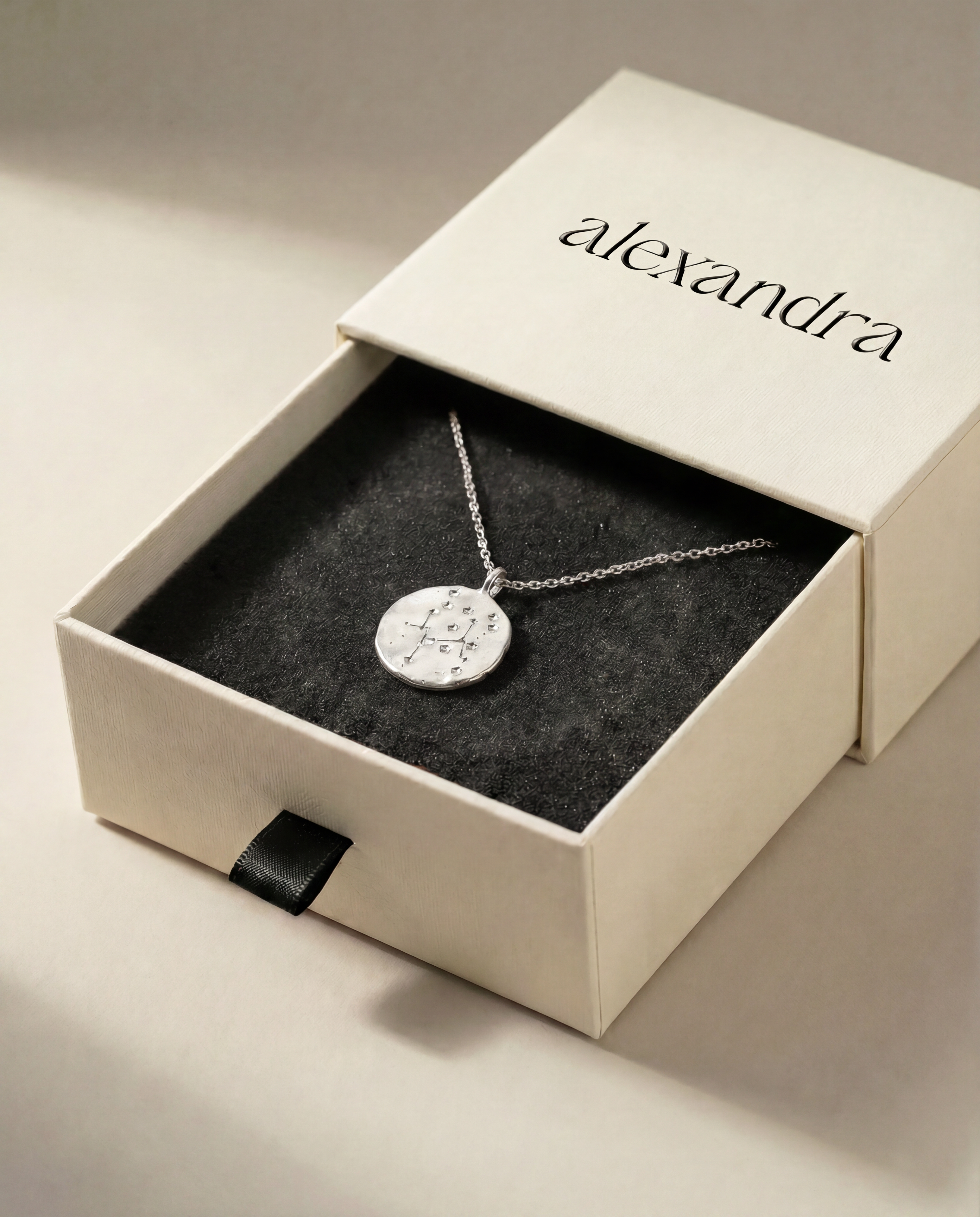 Silver necklace with a pendant in an 'alexandra' branded box.