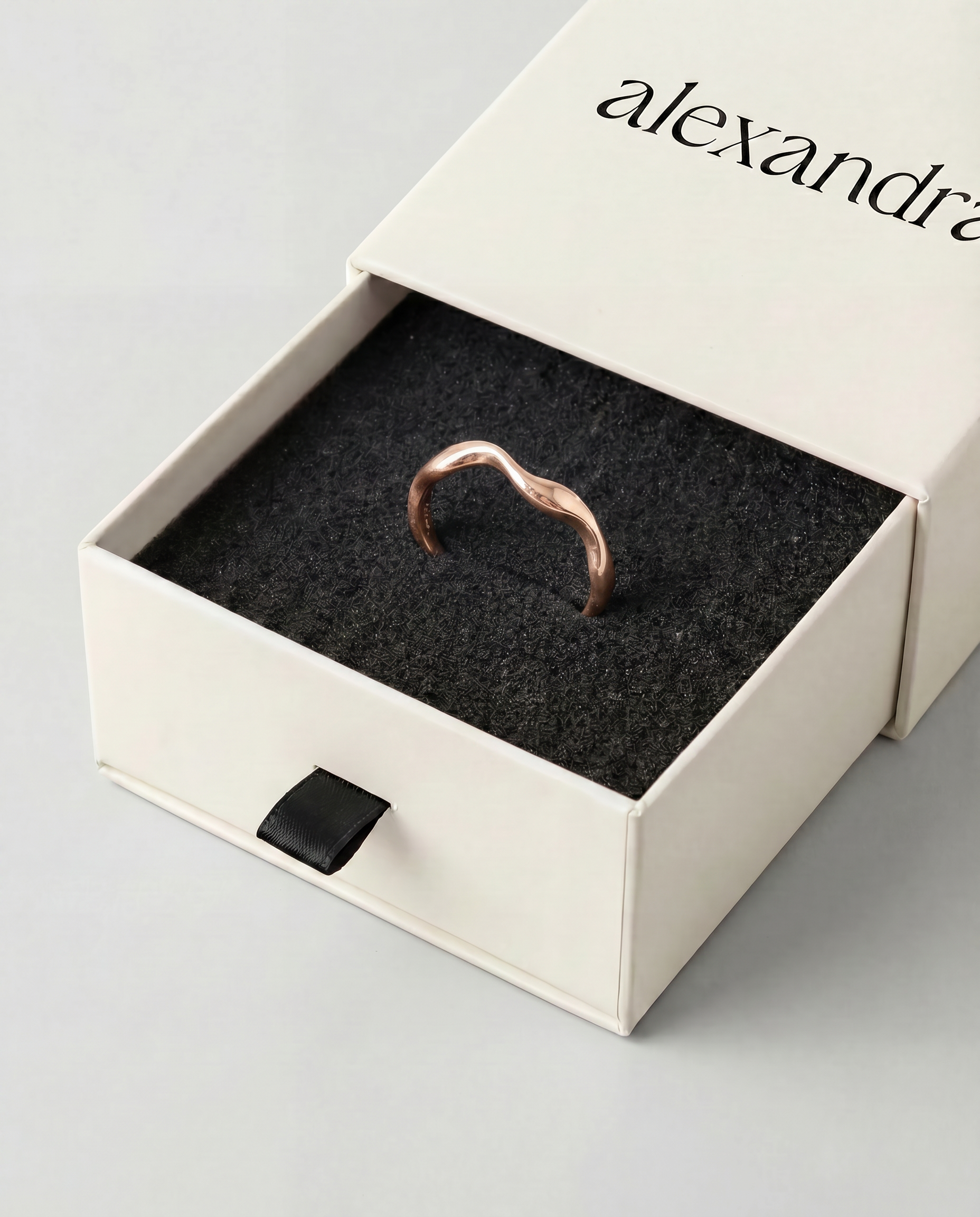 Elevated rose gold ring in box labeled alexandra