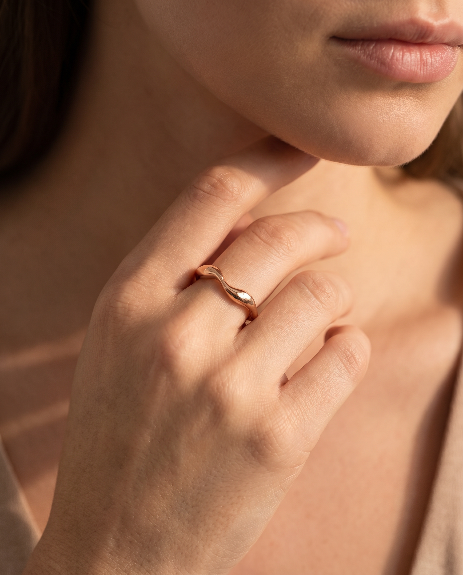 Luxury Rose gold ring on a woman's finger with a soft focus background