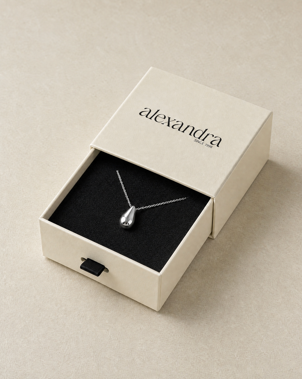 Refined Silver necklace in an open 'alexandra' box on a neutral background