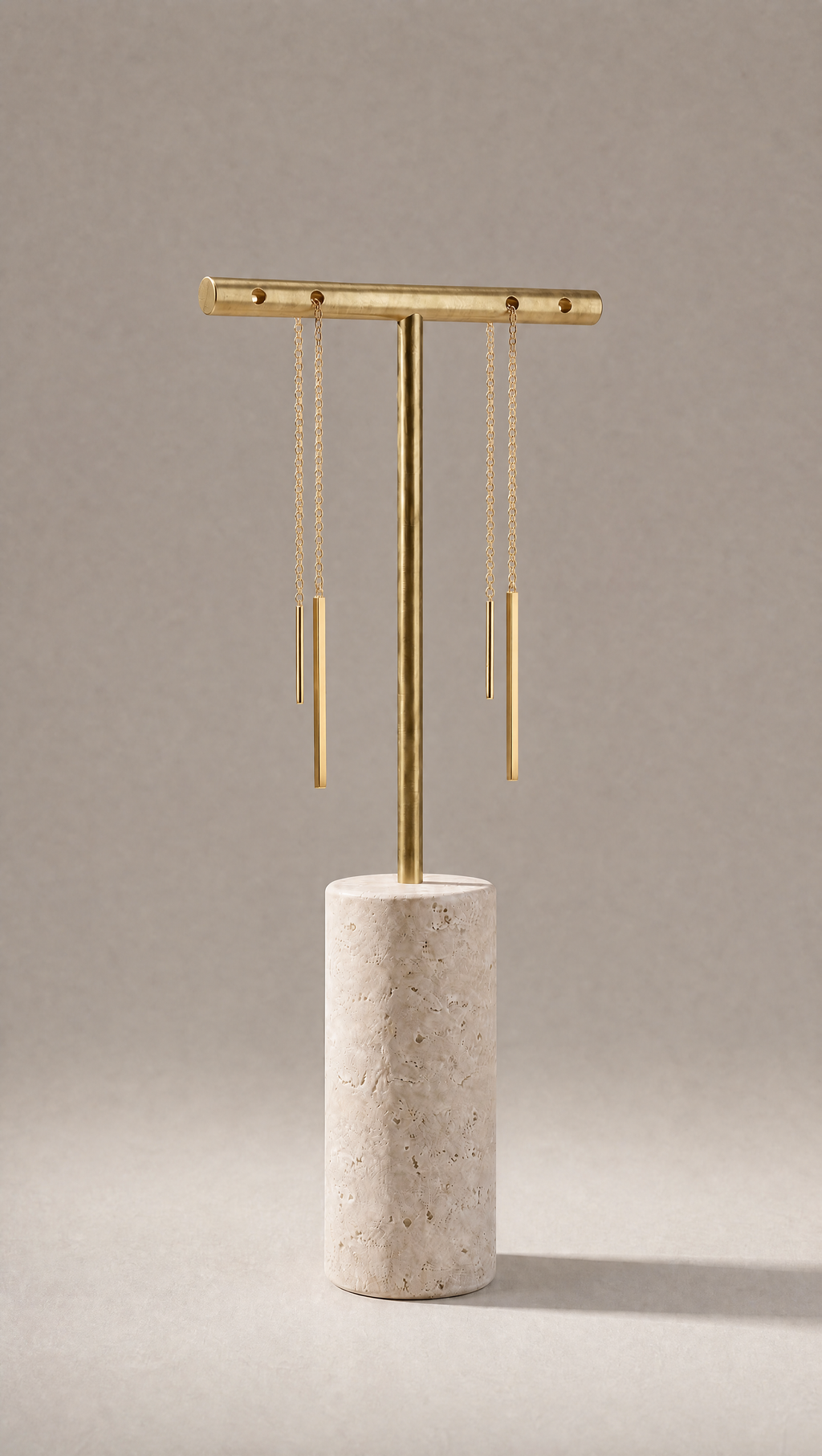 Delicate luxury gold thread earrings on a marble stand 