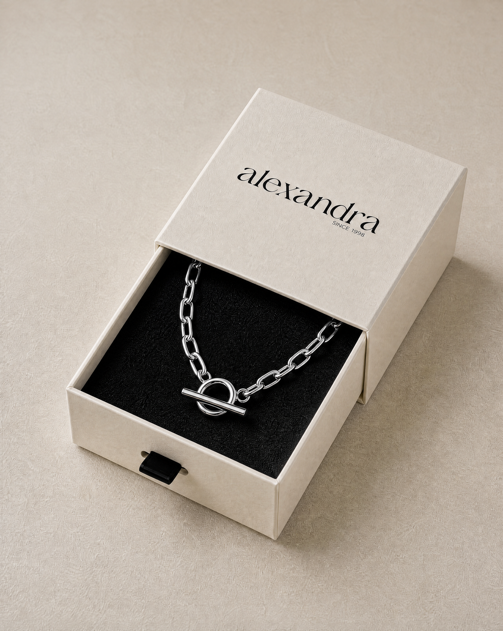 Elevated Silver necklace in an open 'alexandra' branded box on a neutral background