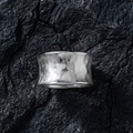 Raw Silver ring on a textured black stone surface