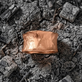 Hammered Rose Gold ring on a textured ashen surface