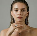 Woman wearing delicate silver strand earrings and a necklace